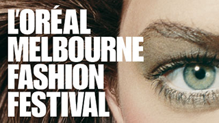 The image features a close-up of an eye with dramatic makeup, accompanied by bold text that reads "L'ORÉAL MELBOURNE FASHION FESTIVAL." The focus is on the striking features and artistic presentation, emphasizing the fashion theme.